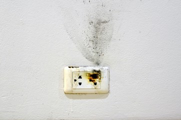 Burnt electric socket from pure standard material.