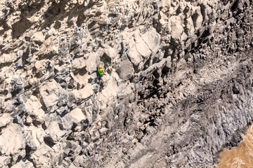 Man Climbing Natural Rock Wall