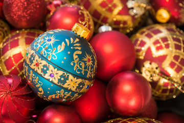 Fancy teal Christmas tree ornament with red and gold decorations