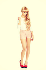 Fototapeta premium Attractive confused woman in shorts.