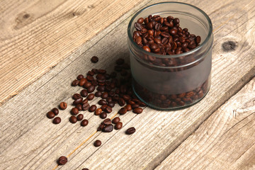 coffee beans in a glass jar on a wooden table