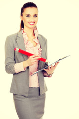 Businesswoman writing with big pencil.