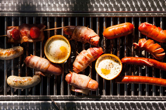  sausages, eggs, bread, pita bread, mushrooms on the grill 