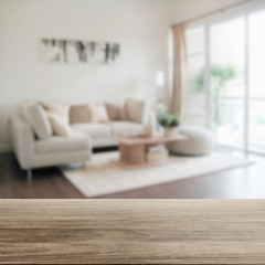 wooden table top with blur of modern living room interior