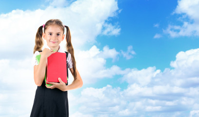 Schoolgirl on blue sky background