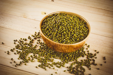 red  beans on wood background - soft focus with vintage film fil