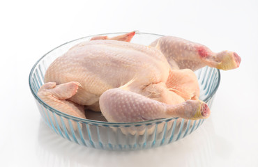 whole raw chicken on baking sheet ready to cook