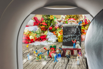 Obraz na płótnie Canvas image of plane window and Christmas ornaments on wood background