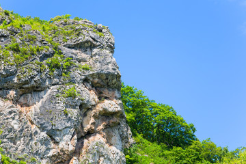 Natural rock in the shape of a human head allocated to the mountain range. Far East, Russia.