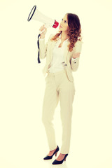 Businesswoman shouting with megaphone.