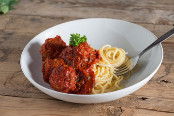Spaghetti and Meatballs in white plate.