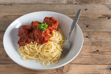 Spaghetti and Meatballs in white plate.