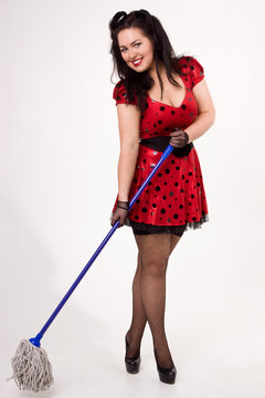Attractive pin-up girl with a mop in his hands