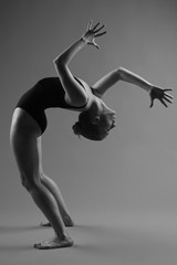 Naklejka premium Modern ballet dancer posing on dark background