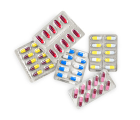 handful of packing different pills on white