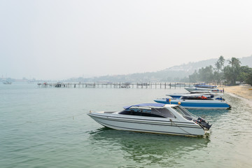 Fototapeta premium Speed Boats moored on tropical sea in Samui Island,Thailand with foggy sky.