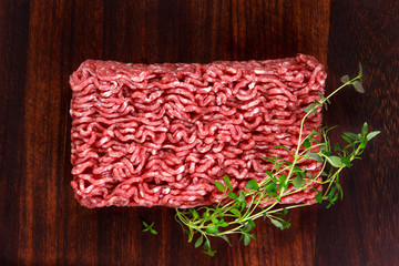 Fresh raw mince beef on wooden table