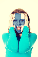 Woman with Finland flag on face.