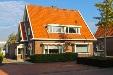 Picturesque residential houses in small Dutch town Zwanenburg, t