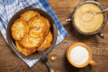 Homemade potato pancakes served with sour cream and brown sugar