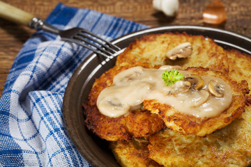Homemade potato pancakes served with mushroom sauce and mushroom
