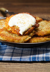 Homemade potato pancakes served with sour cream and brown sugar