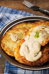 Homemade potato pancakes served with mushroom sauce and mushroom