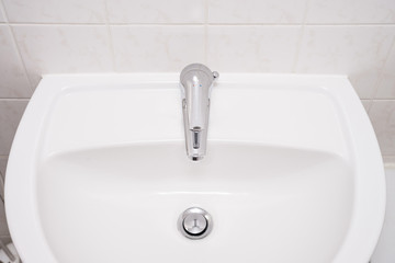 Clean sink and chrome faucet in a bathroom