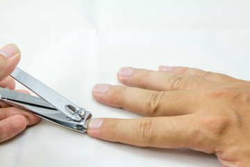 man cut fingernail with herself