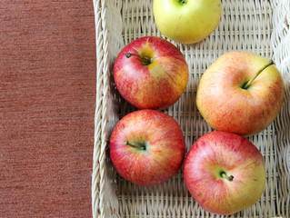 Ripe red apples on wooden background