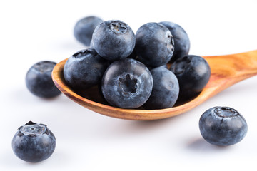 Fresh blueberries in wooden spoon