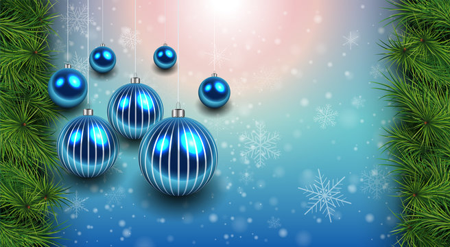 Christmas background with blue shiny balls and fir branches