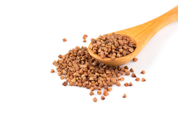 Uncooked buckwheat on wooden spoon