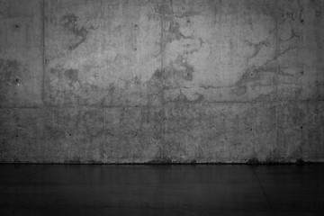 Grungy dark concrete wall and wet floor