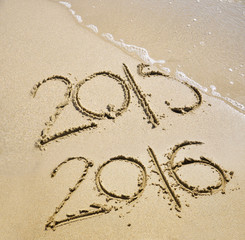 2015 and 2016 written on the beach