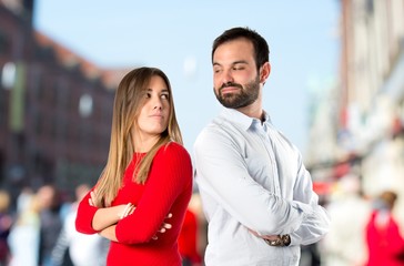 Couple with their arms crossed over isolated background