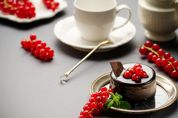 Chocolate cake with a red currant