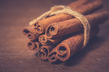 Cinnamon sticks on wooden background