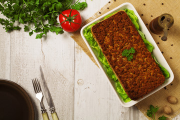 Homemade meat pie with vegetables, served with cranberry sauce