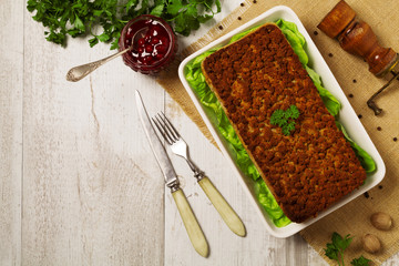 Homemade meat pie with vegetables, served with cranberry sauce