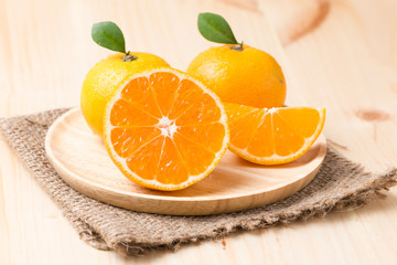 slice orange fruit on wood plate