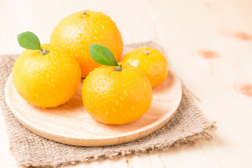 orange fruit on wood plate