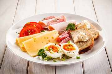 Breakfast - boiled egg, bacon, cheese and vegetables 