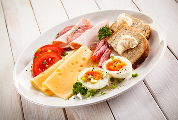 Breakfast - boiled egg, bacon, cheese and vegetables 