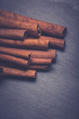 Cinnamon sticks on dark slate background