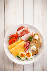 Breakfast - boiled egg, bacon, cheese and vegetables 