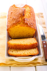 Citrus polenta cake, sliced on plate,