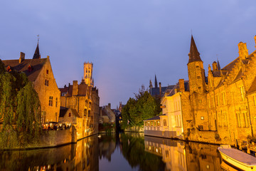 Fototapeta na wymiar Image of Rozenhoedkaai at dusk in Bruges,Belgium with belfry tow