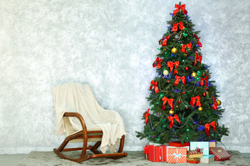 Decorated Christmas tree on light wall background