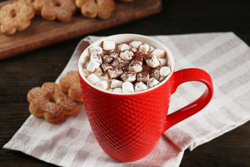 A cup of tasty cocoa and marshmallow on the table